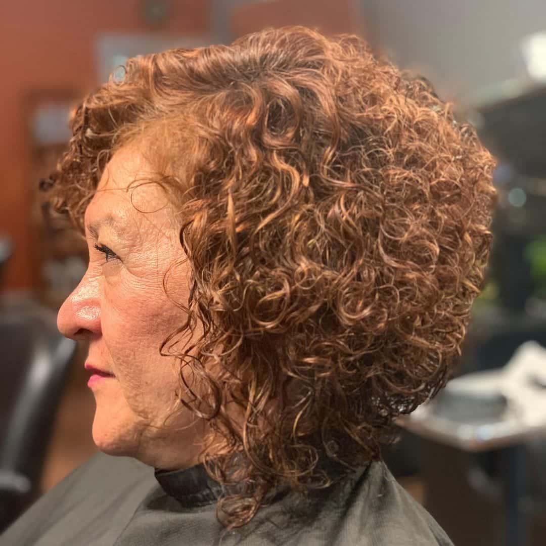 curly hair senior women asymetrical bob