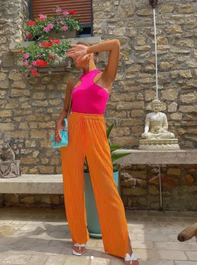 Orange pants with hot pink shirt